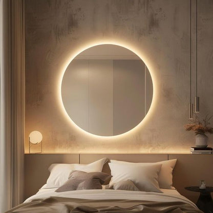 modern round LED wall mirror with warm backlight above bed luxury bedroom décor