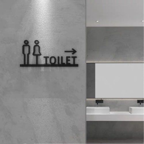 Modern toilet direction sign with male female icons and right arrow
