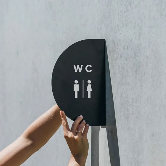 Modern WC restroom blade sign with men women washroom symbols for hanging wall bathroom signage.
