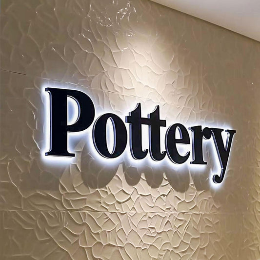 Pottery backlit LED letter sign halo lit 3D wall logo signage textured wall interior