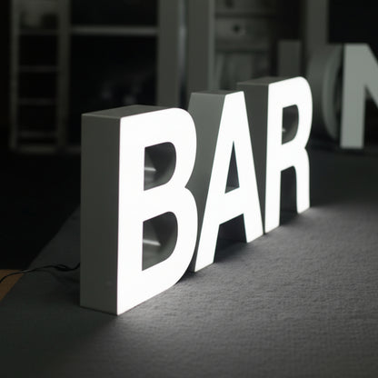 premium white illuminated channel letters hanging sign retail store branding modern interior