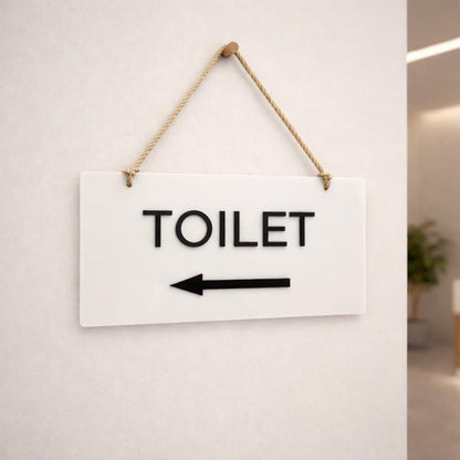 Toilet directional hanging sign with left arrow for washroom navigation
